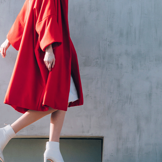 Elegant-woman-wearing-second-hand-red-coat-and-walking